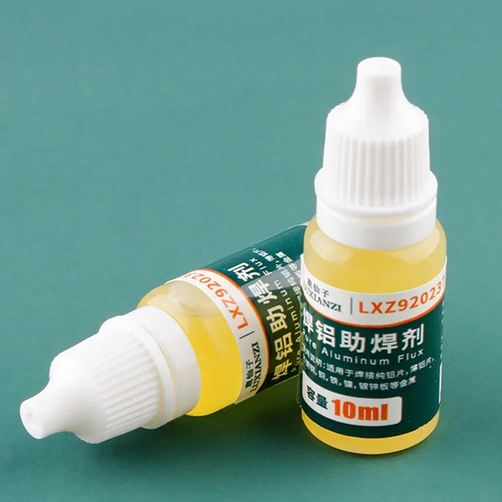 Two exact 10 ml yellow multi-metal soldering flux bottles on a teal background